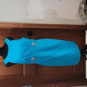 Blue dress with pearl buttons on each side of waist. Roughed back with zipper.
